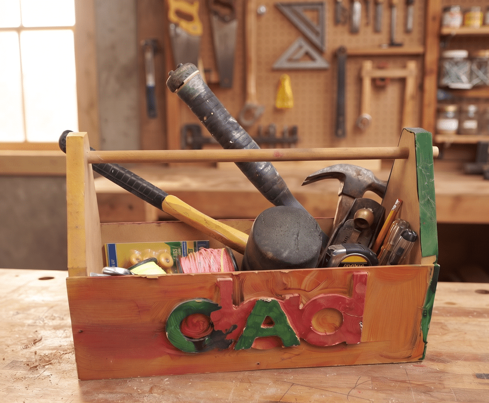 DIY wooden toolbox build — handmade toolbox with dad carved lettering sitting on a workbench in a workshop